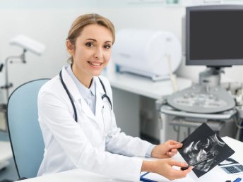 Radiologist presenting ultrasound (USG) report to a patient.